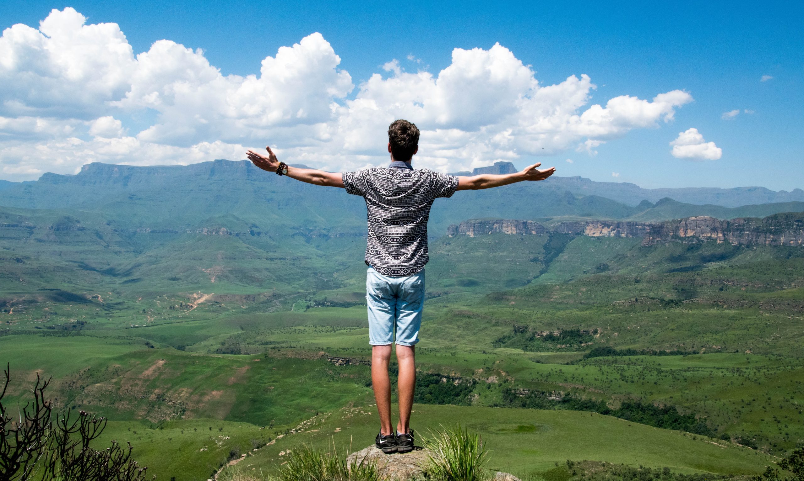 man at the top of a mountain